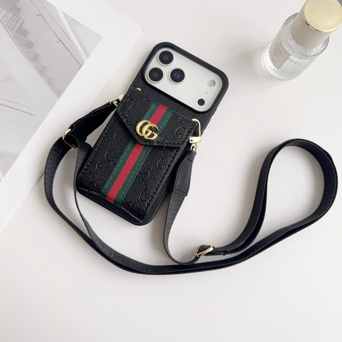 Black Gucci-pattern wallet phone case with a red and green stripe and carrying strap
